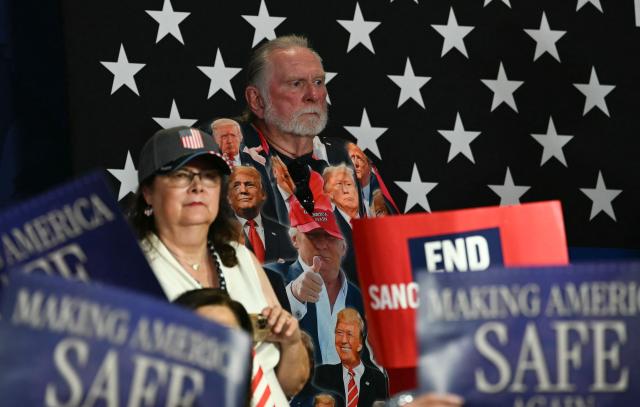 Supporters listen to US President Donald Trump speak at a rally at Gastonia Municipal Airport in Gastonia, North Carolina, on September 16, 2026. Trump is campaigning for Republican US Senate candidate Michael Whatley. (Photo by Brendan SMIALOWSKI / AFP)