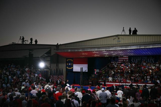 Counter-snipers keep watch from a rooftop as US President Donald Trump speaks at a rally at Gastonia Municipal Airport in Gastonia, North Carolina, on September 16, 2026. Trump is campaigning for Republican US Senate candidate Michael Whatley. (Photo by Brendan SMIALOWSKI / AFP)