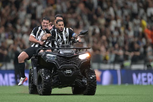 Mineiro players celebrate on a motor-bike after winning the Copa Sudamericana quarter-final second leg football match between Brazil's Atletico Mineiro and Santos at the Arema MRV stadium in Belo Horizonte, Minas Gerais state, Brazil on September 16, 2026. (Photo by DOUGLAS MAGNO / AFP)