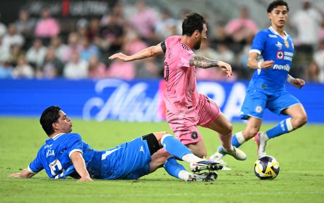 Cruz Azul's midfielder #17 Amaury Garcia slides to stop Inter Miami's Argentine forward #10 Lionel Messi as he runs with the ball during the Campeones Cup final football match between Inter Miami CF and Mexico's Cruz Azul at Nu Stadium in Miami, Florida, on September 16, 2026. (Photo by CHANDAN KHANNA / AFP)