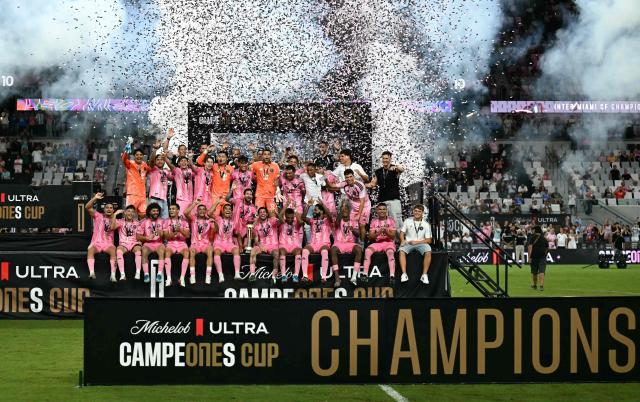 Inter Miami's Argentine forward #10 Lionel Messi holds up the trophy with teammates after his team defeated Mexico's Cruz Azul in the Campeones Cup final at Nu Stadium in Miami, Florida, on September 16, 2026. (Photo by CHANDAN KHANNA / AFP)