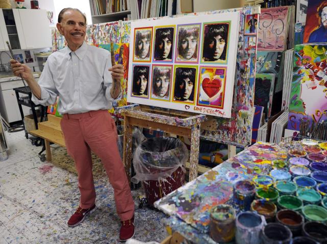 (FILES) Pop artist Peter Max  poses in his New York studio on June 18, 2012 with seven portraits he created of Sir Paul McCartney to commemorate McCartney’s 70th birthday. American artist Peter Max, known in particular for designing the cover of the Beatles’ 1969 album “Yellow Submarine,” has died at the age of 88, his son announced on the US network ABC News on September 16. Born in 1937 in Berlin and forced to flee Nazi Germany with his family, Peter Max became in the 1960s an artist whose brightly colored, psychedelic-inspired works were distributed across a wide range of products. (Photo by Timothy A. CLARY / AFP)