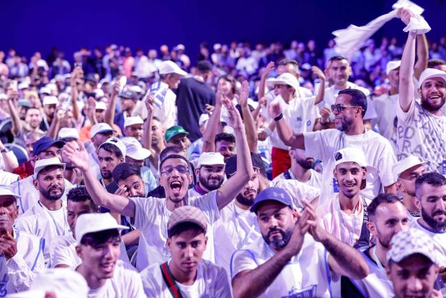 Members and supporters of the Authenticity and Modernity Party (PAM), cheer as they attend a party rally in Tangier on September 16, 2026, as part of PAM's electoral campaign ahead of Morocco's legislative elections, scheduled for September 23. Campaigning for Morocco's legislative election opened on September 10, with the governing coalition seeking to retain power amid discontent over economic and regional inequalities. The disparities are set to be a major issue in the vote, which will be held days before the first anniversary of a youth-led protest movement. (Photo by Abdel Majid BZIOUAT / AFP)