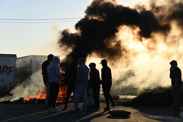 French fishermen burn tires along a road to block access to the oil depot in Frontignan, near Sète, southern France, on September 17, 2026, during a protest aimed at drawing the government's attention to rising fuel prices and deteriorating working conditions. (Photo by Sylvain THOMAS / AFP)