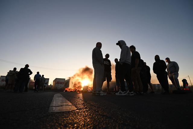 French fishermen burn tires along a road to block access to the oil depot in Frontignan, near Sète, southern France, on September 17, 2026, during a protest aimed at drawing the government's attention to rising fuel prices and deteriorating working conditions. (Photo by Sylvain THOMAS / AFP)