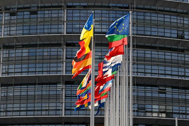 This photograph shows the European flag surrounded by the national flags of the EU member states flapping in the breeze in front of the Louise Weiss building, headquarters of the European Parliament, in Strasbourg, eastern France on September 17, 2026. (Photo by Jean-Christophe VERHAEGEN / AFP)