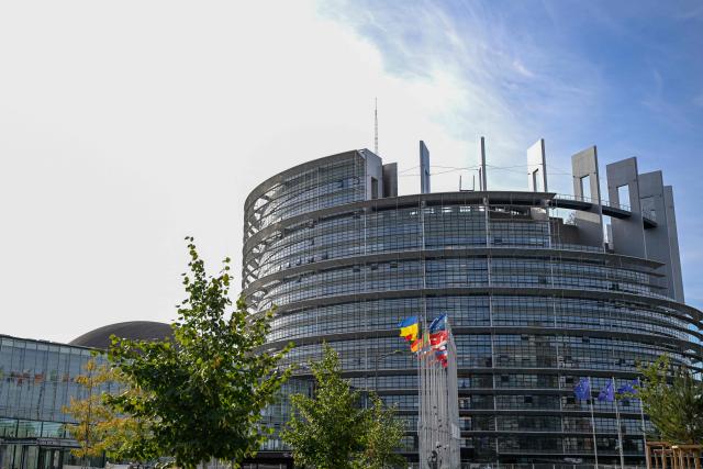 This photograph shows the European flag surrounded by the national flags of the EU member states flapping in the breeze in front of the Louise Weiss building, headquarters of the European Parliament, in Strasbourg, eastern France on September 17, 2026. (Photo by Jean-Christophe VERHAEGEN / AFP)