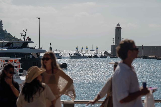 Holidaymakers wait on a quay at the port of Nice, in southeastern France, on September 17, 2026, after fishermen blocked the entrance to the port to protest against soaring fuel prices. Fishermen block access to a fuel depot in Frontignan (Herault) on the morning of September 17, 2026, as well as the ports of Sete and Nice, "symbolic" actions to raise the alarm over the rise in fuel prices, ahead of a meeting scheduled with the fisheries minister at the end of the morning. (Photo by Frederic DIDES / AFP)