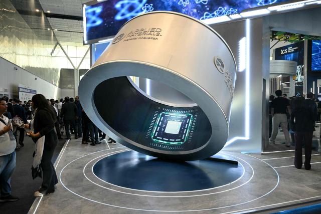 Visitors gather around an installation displaying microprocessor chips during the SEMICON India 2026 Conference & Expo on the semiconductor and electronics ecosystem at Yashobhoomi Convention Centre in New Delhi on September 17, 2026. Prime Minister Narendra Modi pitched India as a new global hub for semiconductor production on September 17, urging technology firms to invest in what he called a "reliable" location. (Photo by Sajjad HUSSAIN / AFP)