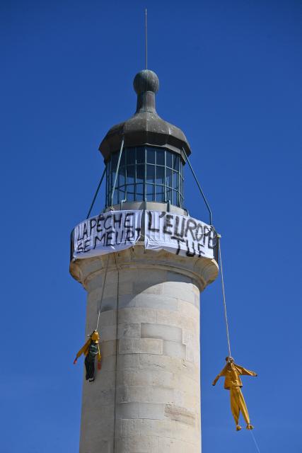 Effigies hang from a lighthouse displaying a banner reading "Fishing is dying, Europe is killing it" during a fishermen's protest against soaring fuel prices, in Grau-du-Roi, southern France, on September 17, 2026. Fishermen block access to a fuel depot in Frontignan (Herault) on the morning of September 17, 2026, as well as the ports of Sete and Nice, "symbolic" actions to raise the alarm over the rise in fuel prices, ahead of a meeting scheduled with the fisheries minister at the end of the morning. (Photo by Sylvain THOMAS / AFP)
