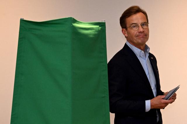 (FILES) Sweden's Prime Minister Ulf Kristersson, leader of the conservative Moderates, prepares to cast his ballot at a polling station in Strangnas near Stockholm, during Sweden's general election on September 13, 2026. Sweden's conservative Prime Minister Ulf Kristersson announced his resignation on September 17, 2026 after the left-wing opposition won a slim majority in parliament in the country's general election. (Photo by Jonathan Nackstrand / AFP)