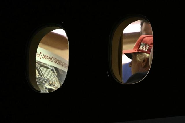 TOPSHOT - US President Donald Trump is seen aboard Air Force One checking a Kennedy Center large printout after landing at Joint Base Andrews, Maryland on September 16, 2026. Trump, who is returning from Gastonia, North Carolina after campaigning for Republican US Senate candidate Michael Whatley, threatened on September 15, 2026 to keep the Kennedy Center closed for good after a judge ruled his name cannot be added onto the famed arts institution's facade. (Photo by Brendan SMIALOWSKI / AFP)