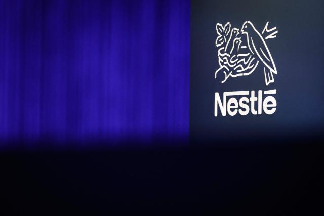 (FILES) This photograph shows the logo of Swiss food giant Nestle during a general shareholders meeting in Ecublens, near Lausanne, on April 16, 2025. Nestlé, sued over illegal dumping near its bottled water plants in the Vosges, western France must be retried, the Nancy Court of Appeal ruled on September 17, 2026, overturning a decision by the criminal court that had annulled in March key analyses implicating the multinational. (Photo by GABRIEL MONNET / AFP)