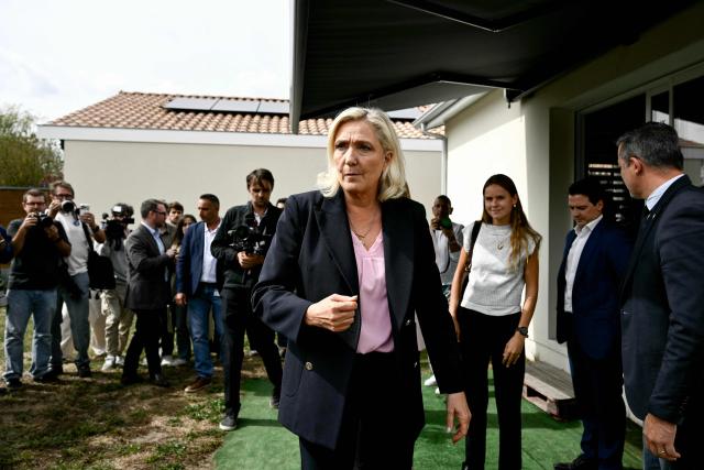 President of the far-right Rassemblement National (RN) parliamentary group and 2027 French presidential candidate Marine Le Pen (C) visits Le Porge, south-western France, on September 17, 2026, months after a wildfire destroyed some 183 homes in the town as part of a broader blaze that swept through the Gironde department this summer.  (Photo by Philippe LOPEZ / AFP)