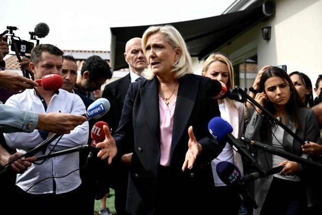 President of the far-right Rassemblement National (RN) parliamentary group and 2027 French presidential candidate Marine Le Pen speaks to the press during her visit to Le Porge, south-western France, on September 17, 2026, months after a wildfire destroyed some 183 homes in the town as part of a broader blaze that swept through the Gironde department this summer.  (Photo by Philippe LOPEZ / AFP)