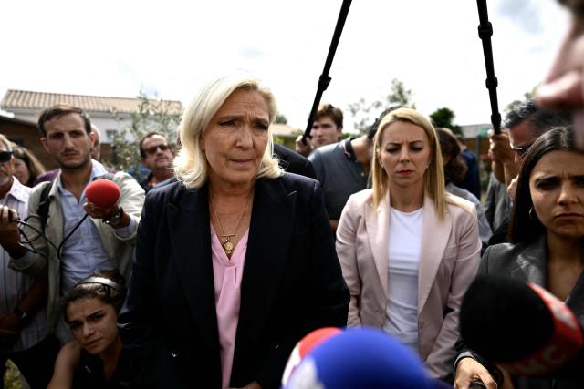 President of the far-right Rassemblement National (RN) parliamentary group and 2027 French presidential candidate Marine Le Pen (C) visits Le Porge, south-western France, on September 17, 2026, months after a wildfire destroyed some 183 homes in the town as part of a broader blaze that swept through the Gironde department this summer.  (Photo by Philippe LOPEZ / AFP)