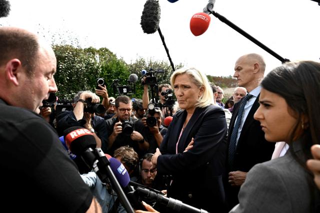 President of the far-right Rassemblement National (RN) parliamentary group and 2027 French presidential candidate Marine Le Pen (C) visits Le Porge, south-western France, on September 17, 2026, months after a wildfire destroyed some 183 homes in the town as part of a broader blaze that swept through the Gironde department this summer.  (Photo by Philippe LOPEZ / AFP)
