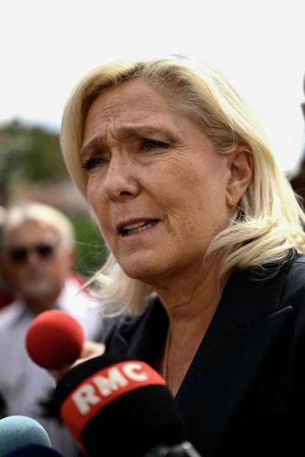 President of the far-right Rassemblement National (RN) parliamentary group and 2027 French presidential candidate Marine Le Pen visits Le Porge, south-western France, on September 17, 2026, months after a wildfire destroyed some 183 homes in the town as part of a broader blaze that swept through the Gironde department this summer.  (Photo by Philippe LOPEZ / AFP)