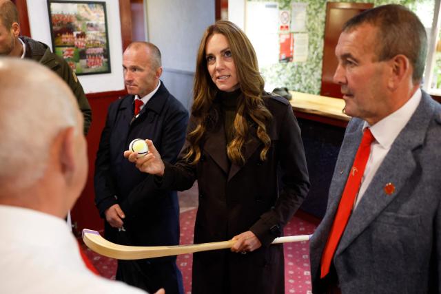 Britain's Catherine (C), Princess of Wales, meets representatives from the club's senior and youth teams, while visiting Bute Shinty Club in Rothesay, in the Isle of Bute, Scotland, on September 17, 2026. (Photo by Jeff J Mitchell / POOL / AFP)