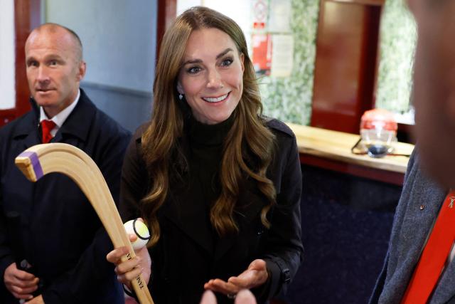 Britain's Catherine (C), Princess of Wales, smiles as she meets representatives from the club's senior and youth teams, while visiting Bute Shinty Club in Rothesay, in the Isle of Bute, Scotland, on September 17, 2026. (Photo by Jeff J Mitchell / POOL / AFP)