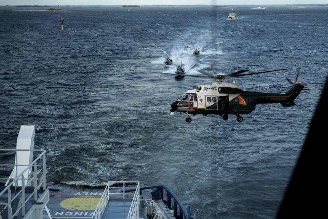 An Airbus Helicopter OH-HVG AS332L Super Puma of the Finnish Border Guard approaches the Finnish icebreaking vessel Polaris, owned and operated by Finnish state-owned company Arctia, as members of Finnish Border Guard, Police and Armed Forces take part in the MARSEC EU 26 joint exercise hosted by the Finnish Border Guard off Helsinki in the Gulf of Finland, Finland on September 17, 2026. MARSEC EU 26 is the European Union's third annual maritime security exercise and is currently taking place in Finland. Hosted by the Finnish Border Guard and organised together with EU Member States and agencies, the exercise supports better coordination and information exchange. Special attention is given to protecting key underwater infrastructure, including cables and pipelines, and to dealing with suspicious maritime activity and potential hybrid threats. (Photo by Alessandro RAMPAZZO / AFP)