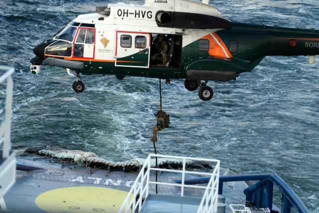 A soldier descends on rope from an Airbus Helicopter OH-HVG AS332L Super Puma of the Finnish Border Guard onto the Finnish icebreaking vessel Polaris, owned and operated by Finnish state-owned company Arctia, as members of Finnish Border Guard, Police and Armed Forces take part in the MARSEC EU 26 joint exercise hosted by the Finnish Border Guard off Helsinki in the Gulf of Finland, Finland on September 17, 2026. MARSEC EU 26 is the European Union's third annual maritime security exercise and is currently taking place in Finland. Hosted by the Finnish Border Guard and organised together with EU Member States and agencies, the exercise supports better coordination and information exchange. Special attention is given to protecting key underwater infrastructure, including cables and pipelines, and to dealing with suspicious maritime activity and potential hybrid threats. (Photo by Alessandro RAMPAZZO / AFP)