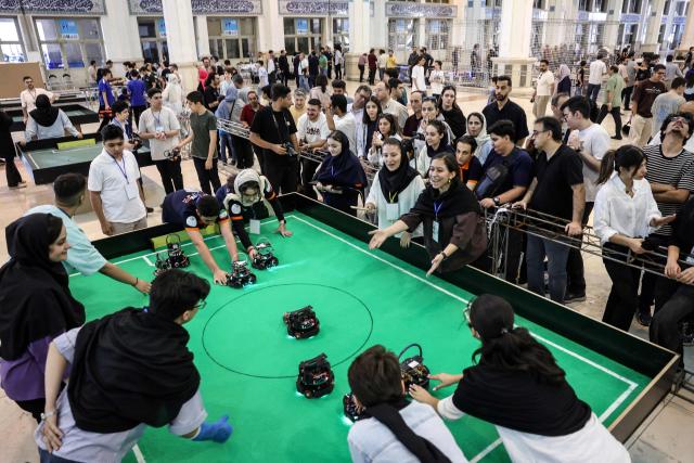 Iranian female students compete in a robotics challenge during the RoboCup IranOpen event at Tehran's Mosallah Mosque on September 17, 2026. (Photo by AFP)