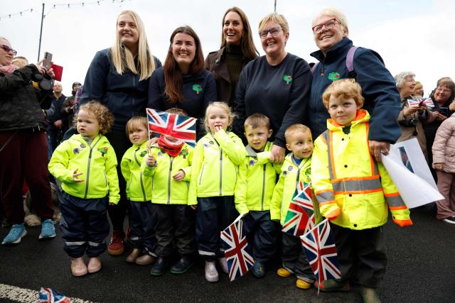 Britain's Catherine, Princess of Wales (top C) poses with members of the community as she and Prince William visit the community-owned Anchor Tavern Pub & Hub in Port Bannatyne in the Isle of Bute, Scotland, September 17, 2026. (Photo by Jeff J Mitchell / POOL / AFP)