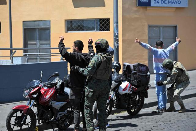Soldiers frisk motorcyclists during a patrol in downtown Quito on September 17, 2026. Ecuador imposed a five-hour nighttime curfew in four coastal provinces affected by drug trafficking-related violence, authorities said, as part of efforts to intensify military and police operations from September 17 to 30, 2026. (Photo by Rodrigo BUENDIA / AFP)