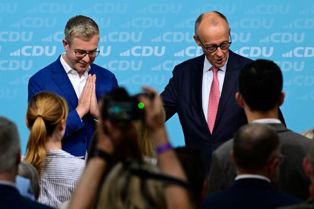 The conservative Christian Democratic Union (CDU) party's lead candidate for the Berlin state election, Stefan Evers (L) and German Chancellor and leader of Germany's Christian Democratic Union (CDU) Friedrich Merz acknowledge the applauds during a campaign event at the CDU headquarters in Berlin, on September 17, 2026. Berlin's State elections take place on September 20, 2026. (Photo by John MACDOUGALL / AFP)