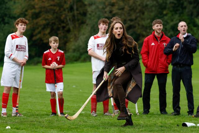 Britain's Catherine (C), Princess of Wales, participates in the sport on the pitch, while visiting Bute Shinty Club in Rothesay, in the Isle of Bute, Scotland, on September 17, 2026. (Photo by Jeff J Mitchell / POOL / AFP)