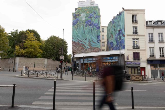 This photograph shows a mural depicting Vincent van Gogh’s iconic painting "Irises" installed by the Getty agency, a cultural and philanthropic organizations dedicated to the visual arts, in Paris on September 17, 2026. Starting October 1, six monumental reproductions of artworks from the Getty Museum collection will be installed at various locations across Paris. (Photo by Kenzo TRIBOUILLARD / AFP)