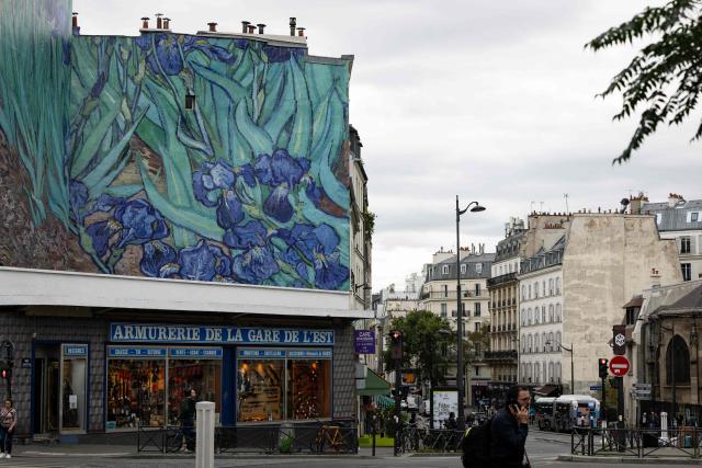 This photograph shows a mural depicting Vincent van Gogh’s iconic painting "Irises" installed by the Getty agency, a cultural and philanthropic organizations dedicated to the visual arts, in Paris on September 17, 2026. Starting October 1, six monumental reproductions of artworks from the Getty Museum collection will be installed at various locations across Paris. (Photo by Kenzo TRIBOUILLARD / AFP)