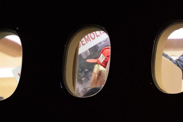 US President Donald Trump is seen aboard Air Force One checking a large Kennedy Center printout after landing at Joint Base Andrews, Maryland on September 16, 2026. Trump, who is returning from Gastonia, North Carolina after campaigning for Republican US Senate candidate Michael Whatley, threatened on September 15, 2026 to keep the Kennedy Center closed for good after a judge ruled his name cannot be added onto the famed arts institution's facade. (Photo by Brendan Smialowski / AFP)