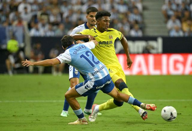 Malaga's Spanish defender #12 Jose Salinas fights for the ball with Villarreal's US defender #03 Alexander Freeman during the Spanish league football match between Malaga CF and Villarreal CF at La Rosaleda Stadium in Malaga on September 17, 2026. (Photo by JORGE GUERRERO / AFP)