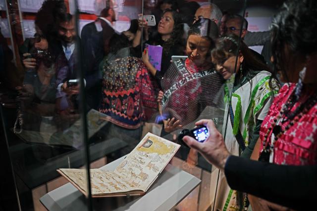 Attendees look at the Azcatitlan Codex, an ancient Aztec pictorial manuscript on loan from France, at the National Museum of Anthropology in Mexico City on September 17, 2026. A cherished 16th-century Mexican manuscript that tells the history of the Aztecs in pictograms goes on display on September 17 in Mexico City, nearly two centuries after it was whisked off to France. (Photo by Carl de Souza / AFP)