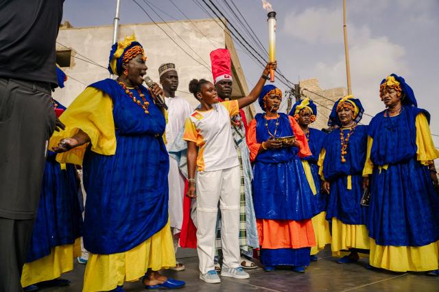A torch bearer carries the Youth Olympic Flame during the flame's 46-day tour in Dakar on September 17, 2026. The Youth Olympic Flame will travel across Senegal's 14 regions before returning to Dakar for the opening ceremony on October 31, 2026. Senegal will host the Summer Youth Olympic Games from October 31 to November 13, 2026, bringing together 2,700 athletes competing in 25 sports. (Photo by Carmen Abd Ali / AFP)
