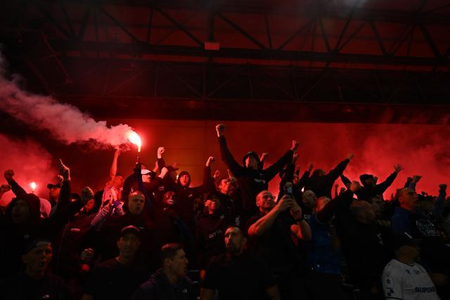 Lech Poznan fans let off flares during the UEFA Europa League, League phase football match between Crystal Palace and Lech Poznan at Selhurst Park in London on September 17, 2026. (Photo by Glyn KIRK / AFP)