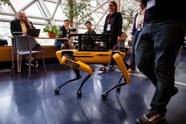 A Boston Dynamics robot dog called "Spot" is seen during day two of the "ALL IN 2026" conference at the Palais des Congres de Montreal in Montreal, Quebec, Canada, on September 17, 2026. "All In" is Canada's largest artificial intelligence and technology event. (Photo by ANDREJ IVANOV / AFP)