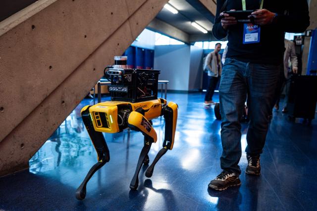 A Boston Dynamics robot dog called "Spot" is seen during day two of the "ALL IN 2026" conference at the Palais des Congres de Montreal in Montreal, Quebec, Canada, on September 17, 2026. "All In" is Canada's largest artificial intelligence and technology event. (Photo by ANDREJ IVANOV / AFP)