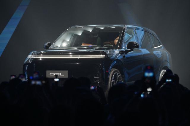 An XPeng G9L SUV  is displayed on stage during its launch ceremony in Beijing on September 17, 2026. The car, which comes in pure electric and hybrid variants, will be produced in factories in Guangzhou, in southern China, and Graz, Austria. (Photo by GREG BAKER / AFP)
