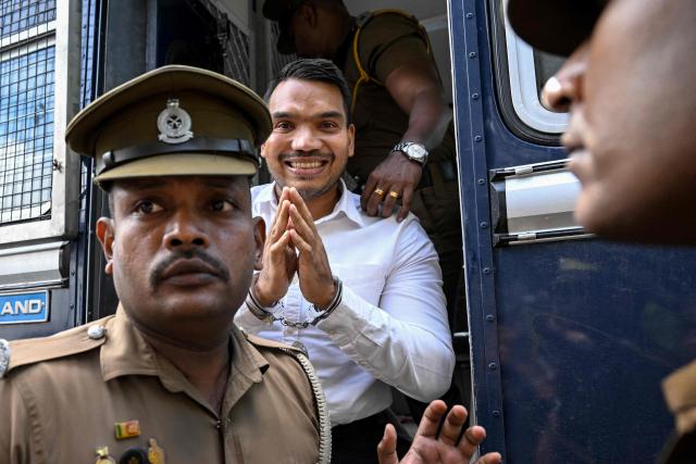 Prison officers escort Sri Lanka's Member of Parliament Namal Rajapaksa (C) to appear before a magistrate at a court in Colombo on September 18, 2026. The opposition lawmaker Rajapaksa is being investigated over allegations linked to a 2013 Airbus aircraft deal signed during his father's presidency. (Photo by Ishara S. KODIKARA / AFP)