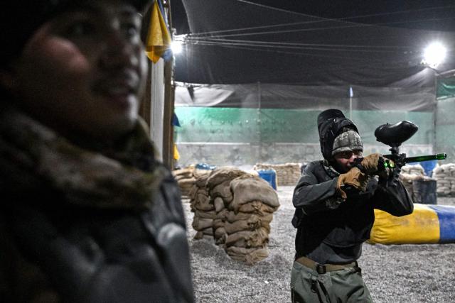 Afghan men compete in a friendly paintball game at the Power Force Paintball Club in Kabul on September 16, 2026. (Photo by Wakil KOHSAR / AFP)