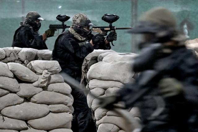 Afghan men compete in a friendly paintball game at the Power Force Paintball Club in Kabul on September 16, 2026. (Photo by Wakil KOHSAR / AFP)