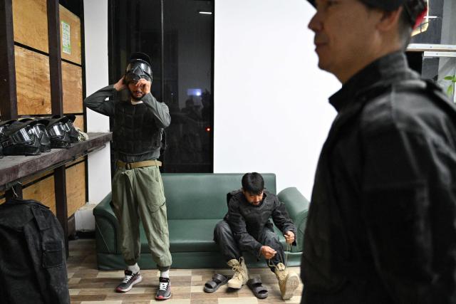 Afghan men wear protective gear before the start of a friendly paintball game at the Power Force Paintball Club in Kabul on September 16, 2026. (Photo by Wakil KOHSAR / AFP)