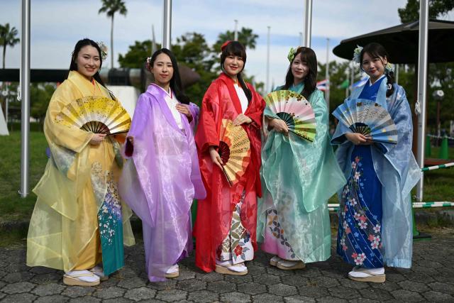 Performers dressed in kimonos strike a pose before welcoming teams at the 2026 Asian Games in Nagoya on September 18, 2026. (Photo by MOHD RASFAN / AFP)