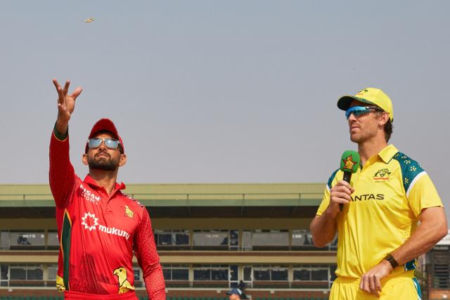 Zimbabwe's captain Sikandar Raza (L) takes the toss while Australia's captain Mitchell Marsh (R) looks on ahead of their second one-day international (ODI) cricket match between Zimbabwe and  Australia at the Harare Sports Club in Harare on September 18, 2026. (Photo by Jekesai NJIKIZANA / AFP)