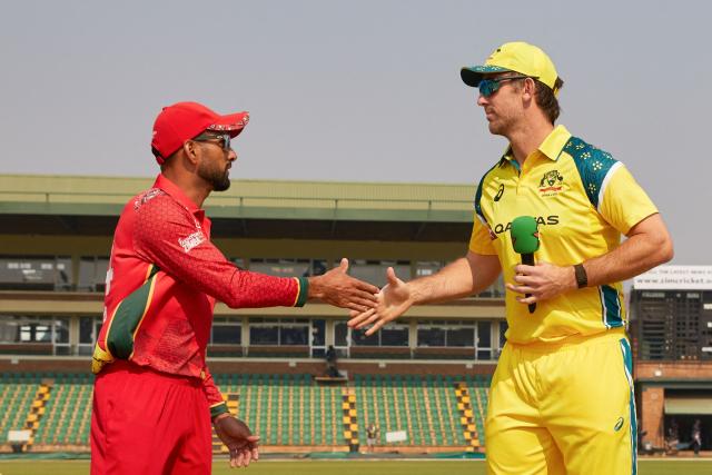Zimbabwe's captain Sikandar Raza (L) shake hands with Australia's captain Mitchell Marsh (R) ahead of their second one-day international (ODI) cricket match between Zimbabwe and  Australia at the Harare Sports Club in Harare on September 18, 2026. (Photo by Jekesai NJIKIZANA / AFP)