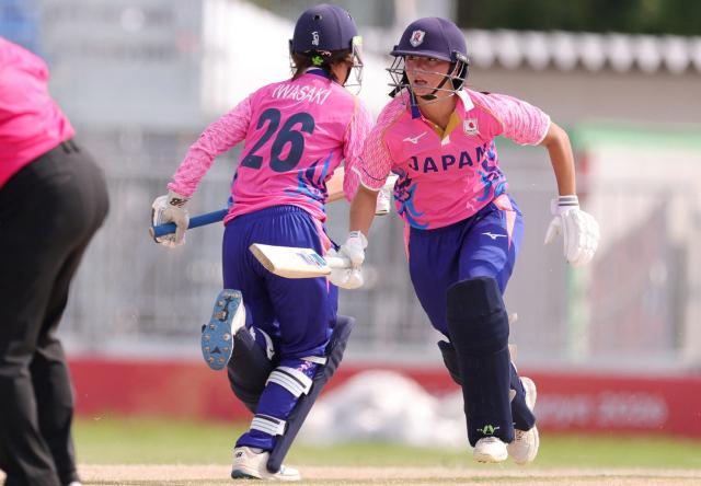 Japan's Ayaka Kato Stafford (R) and Japan's Haruna Iwasaki (L) run between the wickets during the women's cricket match between Japan and India at the 2026 Asian Games in Nagoya on September 18, 2026. (Photo by JIJI Press / AFP) / Japan OUT