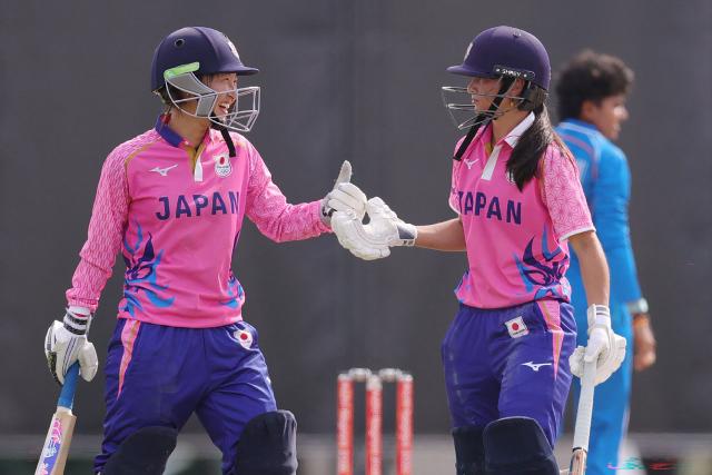 Japan's Ayaka Kato Stafford (R) and Japan's Haruna Iwasaki (L) celebrate during the women's cricket match between Japan and India at the 2026 Asian Games in Nagoya on September 18, 2026. (Photo by JIJI Press / AFP) / Japan OUT